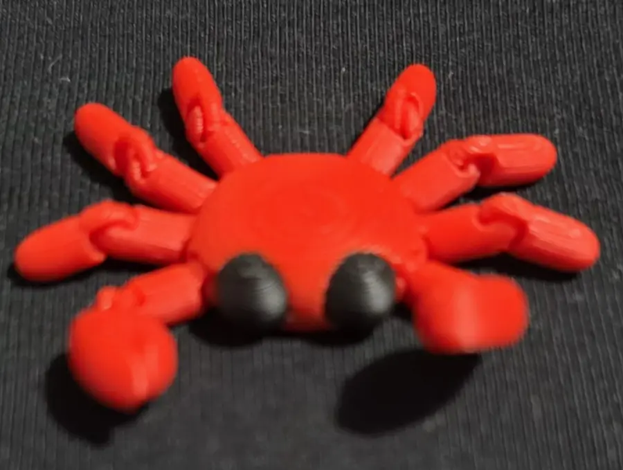 Red articulated crab fidget, close up