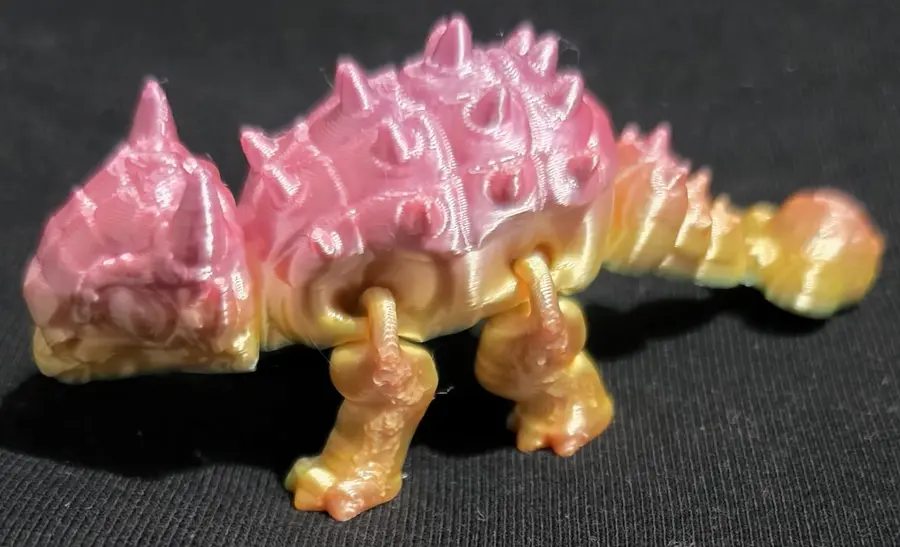 Small ankylosaurus, pink and gold, side view